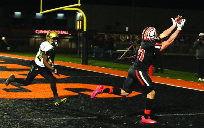 Camden Crooks catches a perfect pass from quarterback Blaze Berlowitz for another Cushing touchdown Friday. Photo by J. D. Meisner