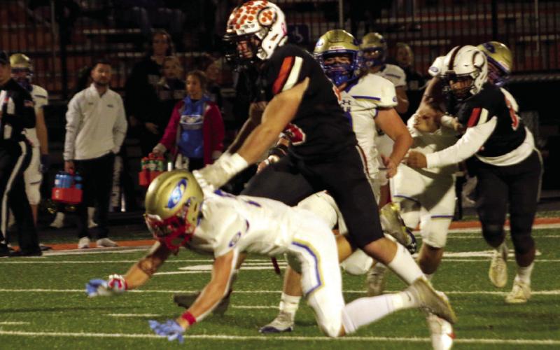 Set The Tone Riley Matheson sets the tone as he pancakes a would-be Mustang blocker. Photos by J.D. Meisner.