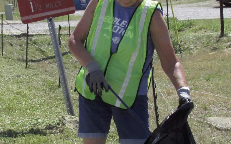 Rotarian and Cushing Lower Elementary Principal Nancy Dowell keeps it clean out on North Kings Hwy.