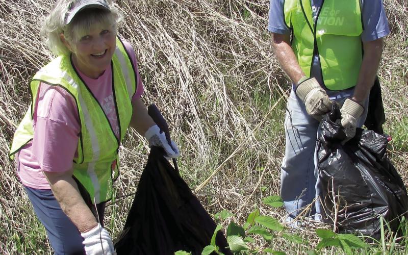 Maria Roberson displays the joys of volunteering with a smile and a trash bag. Dena Morgan and Tyson Branyan were digging in ditches to make sure they cleared all the litter in their section of Kings Highway.