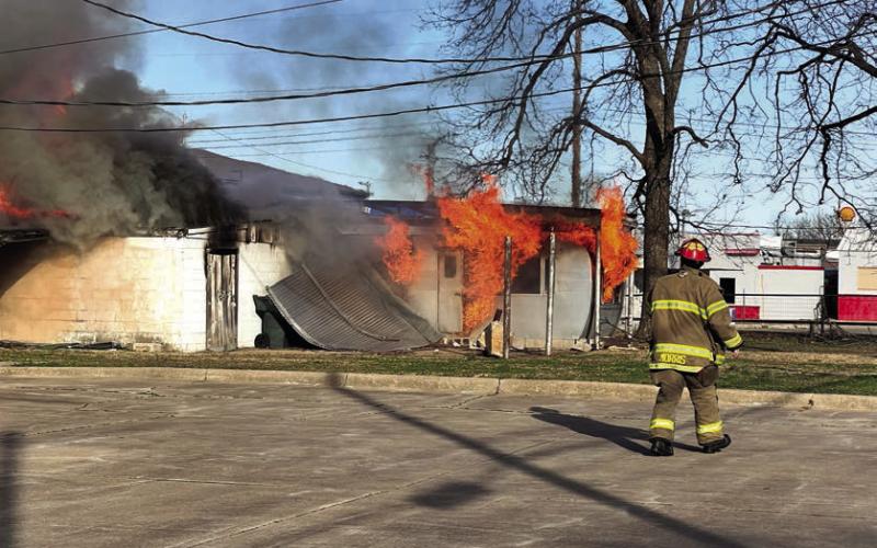 Cushing Fire Captain Tyler Morris, among the first to arrive at the scene, takes an assessment to help plan his department’s attack strategy. Photo by J. D. Meisner