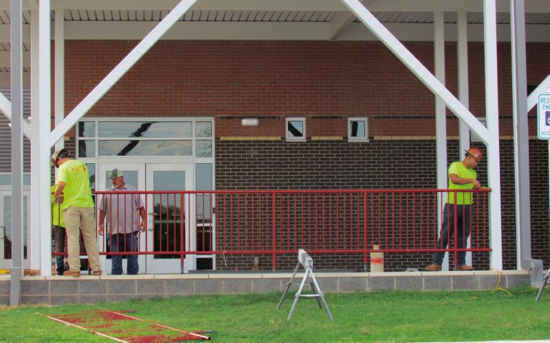 Crewmembers from Allied Steel install railings and make last-minute touches to the new Cushing Elementary School last week. The building was deemed ready for students for the opening of school on Aug. 13 school began on August 13 this week.