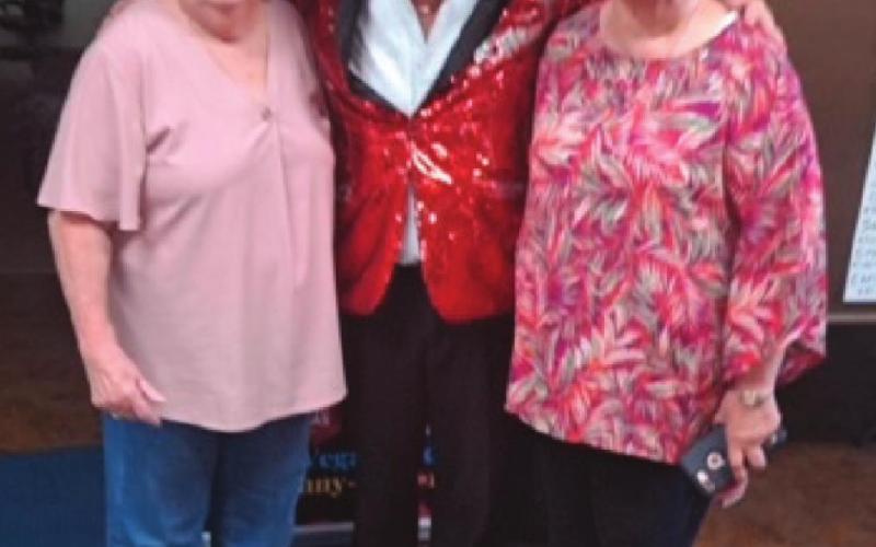Wanda Duckworth and Nancy Franklin pace for a photo with entertainer Jonny Bird.