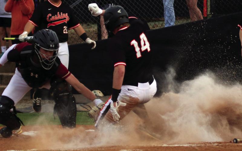 Statler Ethridge slides into home while dodging the Lincoln Christian catcher’s glove. Photos by Allie Prater