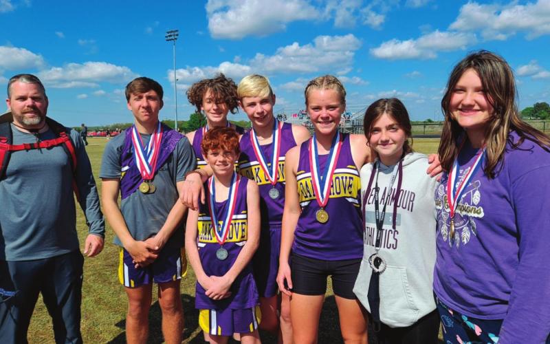 Oak Grove’s Track team came home from the recent ORES State Track meet with three state champs and a lot of podium finishes. Pictured rom left are, Coach Nate Walker, Klayton Kinnin, Tony Six, Cole Cooper, Cora Eyler, Mya Bridgeman, and Hailee Allen. In the front is Owen Collier.