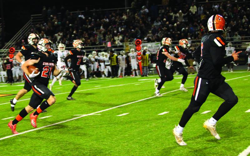 Camden Crooks, flanked by a host of Tiger blockers returns a punt to score Cushing’s fifth touchdown against the Elk City Elk.