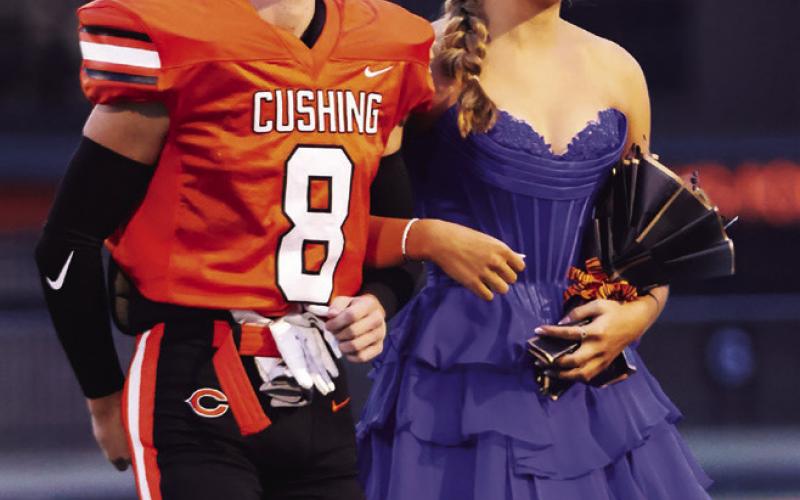 King candidate Jordan Kersey escorts queen candidate Brittan Blakemore.