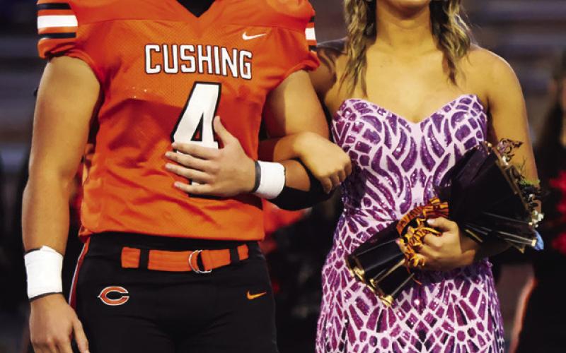 King candidate Kellen Fry escorts queen queen Gracyn Presley.