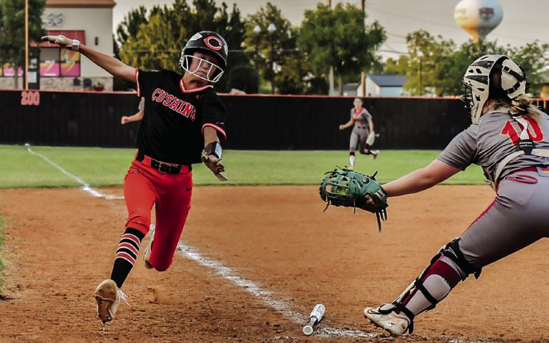 Harli York does a great job avoiding the tag-out at home. Photo by Sarah Townes