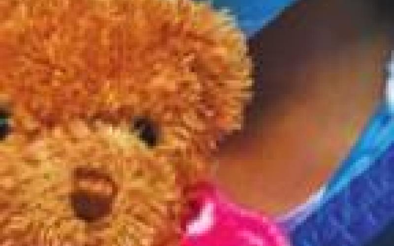 Left: Tobyn Jenkins holds Beary, who was rescued by staff members at Hillcrest Hospital Cushing after being lost during an out of town trip.