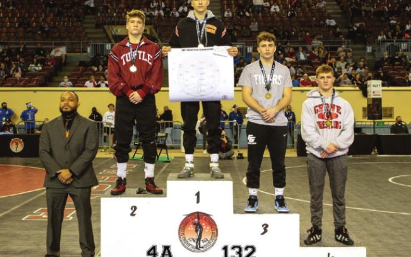 Luke Ahrberg and Hayden Lemmons stand atop the podiums in their respective weight classes after claiming individual state wrestling titles at the OSSAA Class 4A Wrestling Championships.