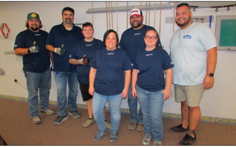 Volunteers came to the Cushing Senior Citizen Center as part of Lowe’s Red Vest Volunteer Day last Friday to provide updates such as installing new baseboards to match the new coat of paint throughout the building.