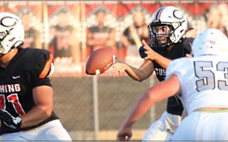 Cushing Tiger Quarterback John Hilligos takes the snap. Photos by Allie Prater.