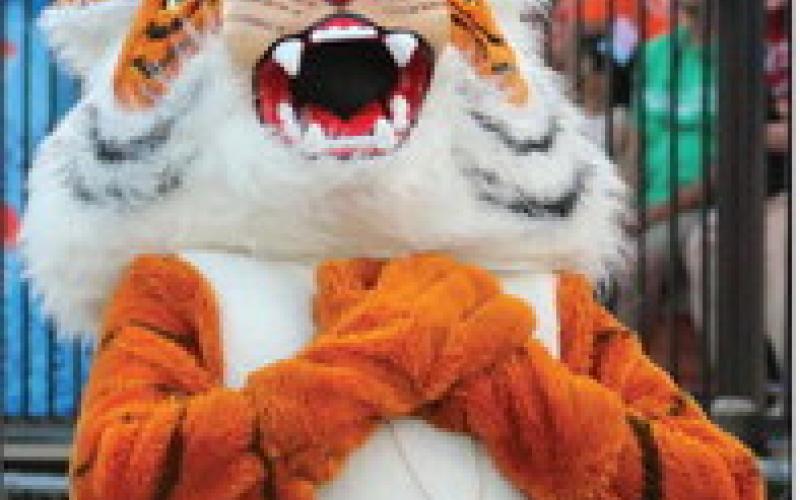 Tony the Tiger holds his heart after being blown a kiss by a Cushing Dance Team member.