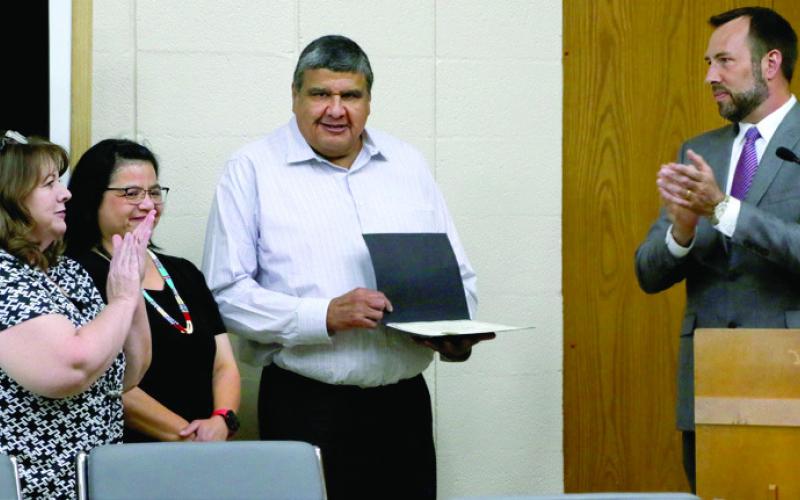 City of Cushing employee Brett Youngman stands with his wife Lavonda after he is presented with a team member recognition award by Tracy Rose from Oklahoma Municipal League and Commission Chairman B.J. Roberson during the commission meeting Monday, June 17, Photo by Allie Prater.