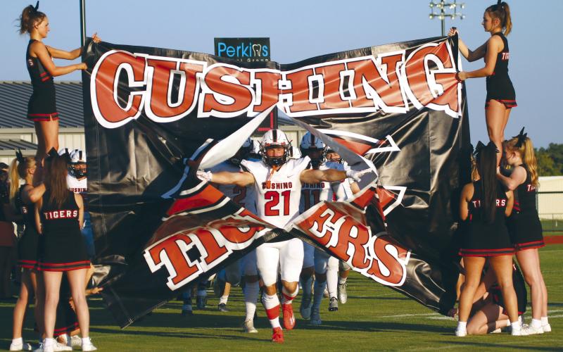 Tiger receiver Camden Crooks breaks through the signs at Perkins Friday