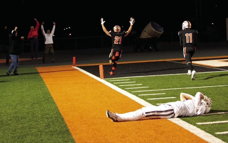 Camden Crooks raises his arms in celebration as he scores another touchdown against the Elks.