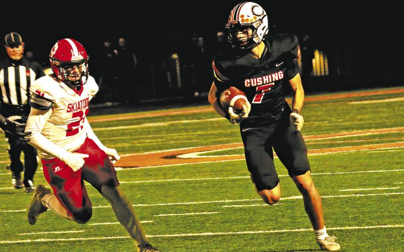 Cushing’s Roman Tucker turns up field en route to a first down Friday against Skiatook.