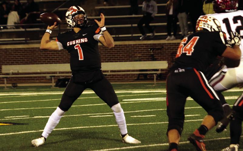 Tiger quarterback Blaze Berlowitz reaches back to throw a pass Saturday in the Class 4A final. Berlowitz threw 54 touchdown passes this season and amassed 3,654 yards of passing. Photo by J.D. Meisner