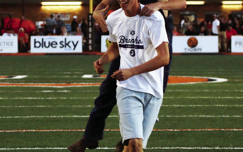 Maddox Morris is congratulated by Jake Collier after Morris successfully kicked a field goal during the Golden Chick’s “Kickin’ for Chicken” contest at halftime of Friday’s Berryhill game. Morris won a 12-piece chicken for his efforts and Collier, who was the holder, probably got a couple pieces. Photo by J. D. Meisner