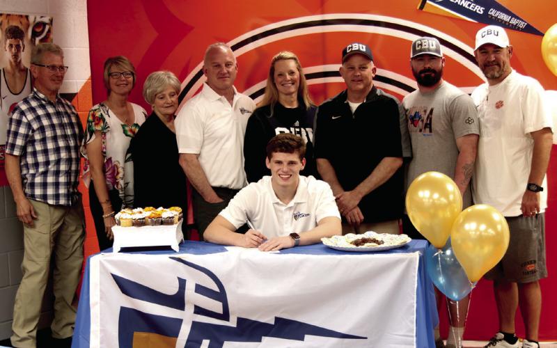 Cushing Tiger and OSSAA Class 4A state champion wrestler Kaiser Simpson signs his letter of intent to attend California Baptist University on a wrestling scholarship. On hand to congratulate Kaiser were hi uncle Bruce Crain, aunt Joanne Crain, Mimi Barbara Rollins, dad Dr. Kasey Simpson, mom Laura Simpson, Tiger Wrestling Head Coach Barry Patterson, Coach Josh Meyers, and Tiger wrestling coach Kyle Fry. Simpson will wrestle for for the CBU Lancers, a Big 12 wrestling program. Photo by J. D. Meisner