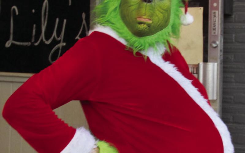 Left: The Grinch found something nice to wear and made his way to Cushing to enjoy scaring…I mean sharing…in the Chamber’s Christmas parade on Dec. 10. Right: Santa was watching during the annual Chamber Christmas parade reminding everyone he sees you when you’re sleeping and knows when you’re awake.