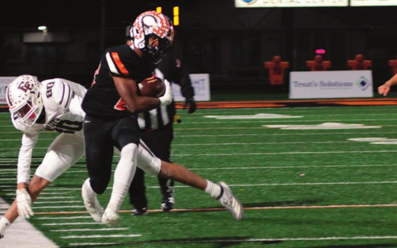 Noah Jones leaps to stay inbounds as he heads up the sidelines.