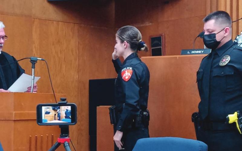 Officer Heather Snow is sworn in by Judge Ahrberg while Officer Jason Beal awaits his swearing in during the City of Cushing commissioner meeting on Monday, Sept. 20.