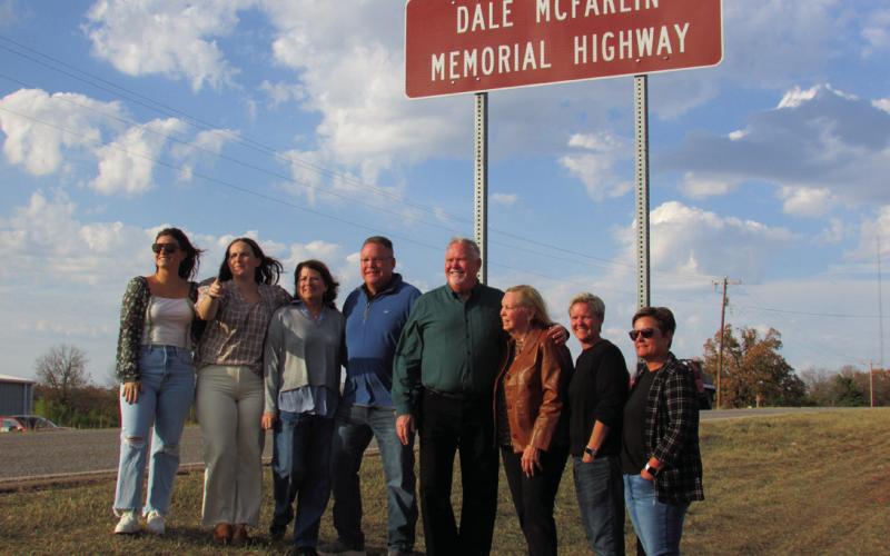 The McFarlin family stands under the newly revealed Dale McFarlin Memorial Highway sign on State Highway 18. Pictured are Dale’s great granddaughters Olivia and Emilie, grandson Kevin and his wife Tammy, son Jim with his wife Debbie, granddaughter Kim and her wife Mindy.