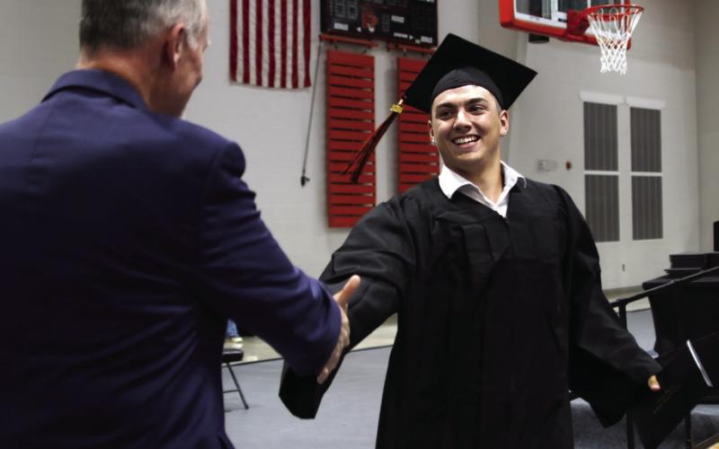 John Hilligoss is greeted by Coates.