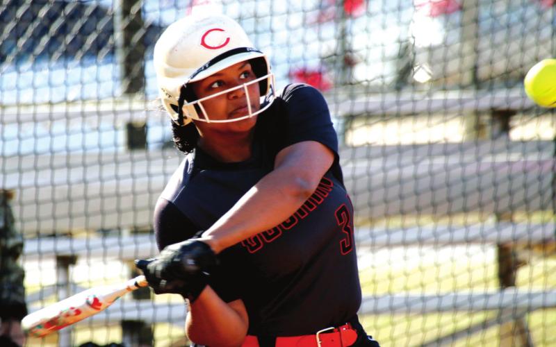 Aove: Nakiyah Jackson brings the bat around to make contact and blast a two-run homer over the centerfi eld fence against Seminole.