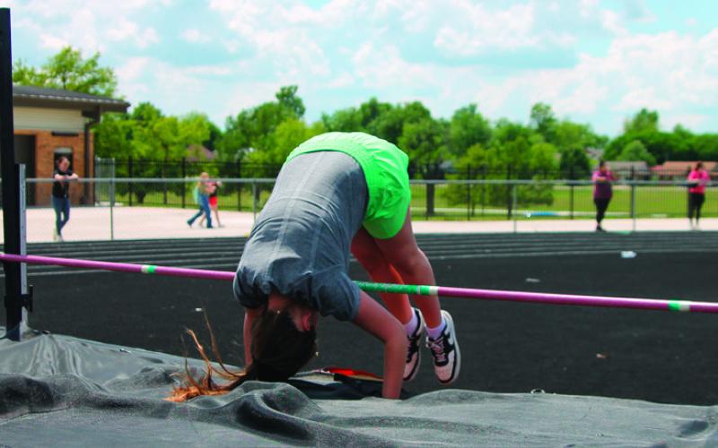 Fifth grade student Alyssa Williamson clears the bar and raises it for the next go — she went on to earn first place in the high jump event.