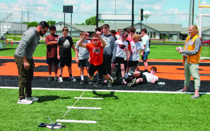 Tate Hancock, 6th grader, leaped forward for the long jump landing in fourth place during the Junior Olympics.