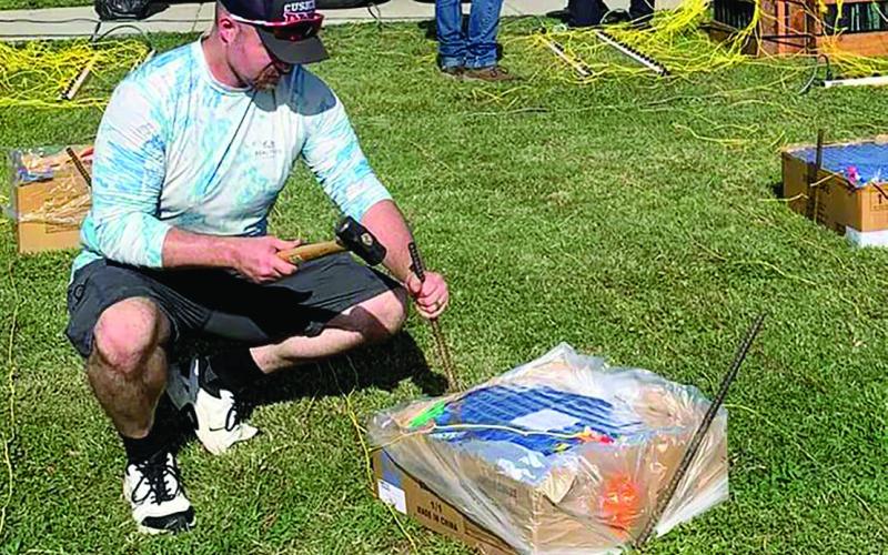 Warren Shideler, Mark Beitz, James Blevins, and Franklin Reed work on getting shells and shot boxes set up for the Cushing Fire Department July 4th firework display in Memorial Park. Photo Courtesy Mark Beitz