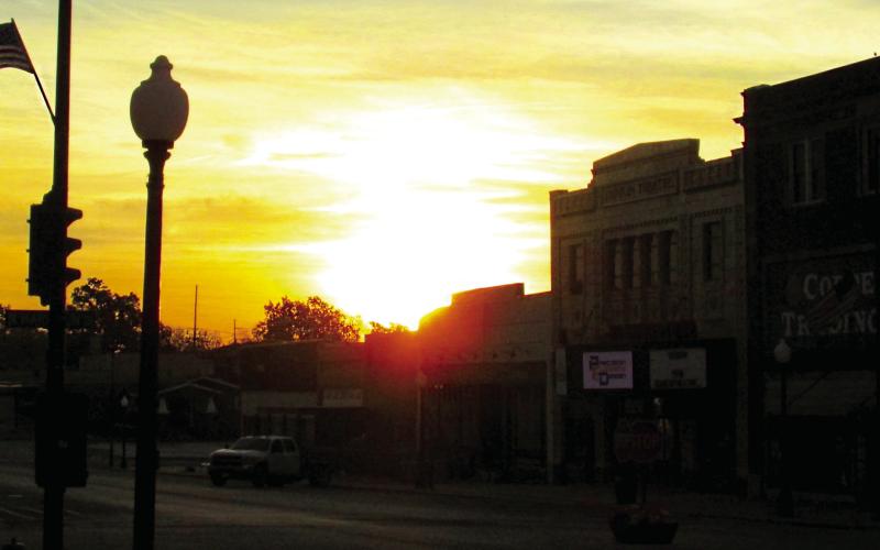 The sun peaks up over the buildings in Historic Downtown Cushing creating a picturesque sunrise on Monday, Oct. 28. Photo by DeAnna Maddox
