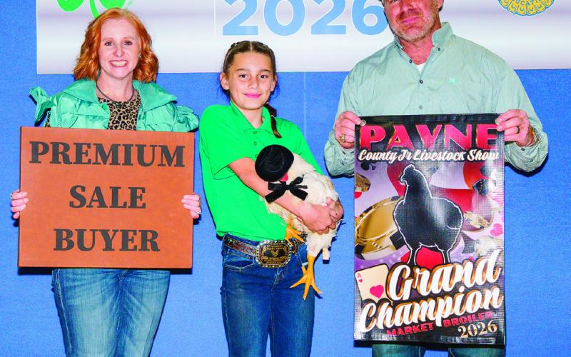 Braylee Dugat of Cimarron Valley 4-H poses with her Grand Champion market broiler sporting a tiny cowboy hat. Dugat earned first place and Grand Champion honors in the Market Broilers division and also had several placings in market goat and breeding doe classes. Photo by Meagan Stephens.
