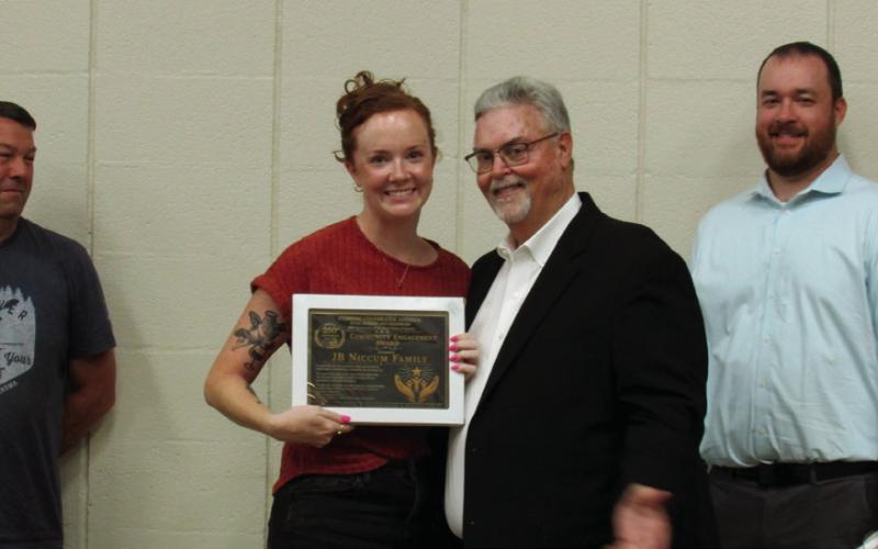 Jessica Niccum accepted a Community Engagement Award on behalf of the JB Niccum family during a special recognition organized by the We Can Cushing members.