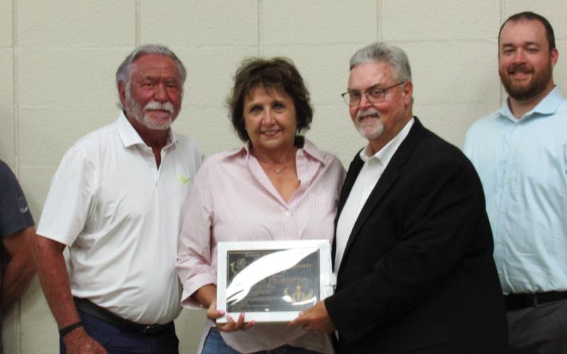 Pictured are Paul and Brenda Magdeburg with Mike Kennedy after being presented with a Community Engagement Award for the support given to the July 4 event by the Bea and Lionel Harris Foundation.
