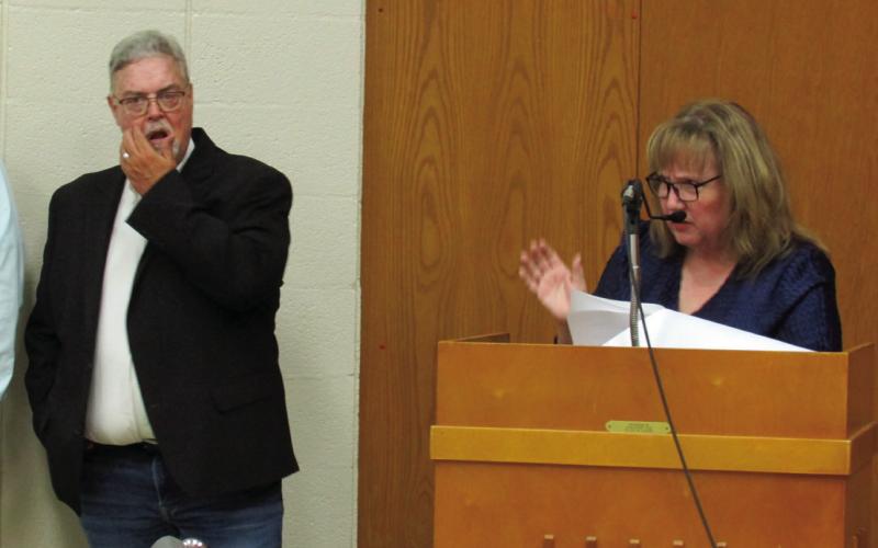 Mike Kennedy stands looking slightly confused as fellow event organizer Sally Wright announces one more surprise award.