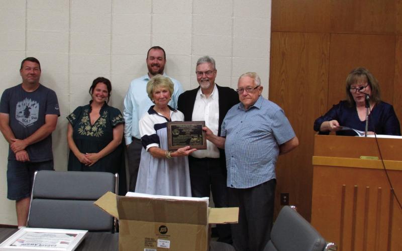 Sue and James Medlock stand with Mike Kennedy and DCRA members Billy Preston, Briea Belveal, and Tyler Stein as they as presented with a recognition plaque for having been selected as Grand Marshals for the July 4 parade that was cancelled due to weather. Photos by DeAnna Maddox