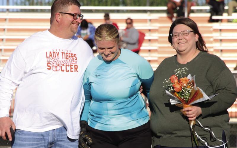 Goal keeper and defender for the Lady Tigers, Zoe Diver is escorted by her parents Michael and Megan Diver.