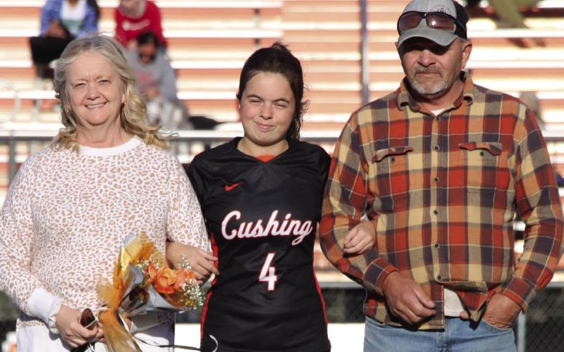 Center mid and defense for the Lady Tigers, Paige Leverich is escorted by her parents, Mike and Sonja Leverich. Photos by Allie Prater