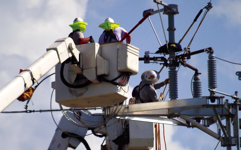 Cushing Electrical Superintendent Mike Stark and personnel from Force Electric and GRDA work to replace a failed switching device on the new line at Ninth Street and Little Avenue last Wednesday. The failure caused a city-wide outage for several hours. Photo by J. D. Meisner