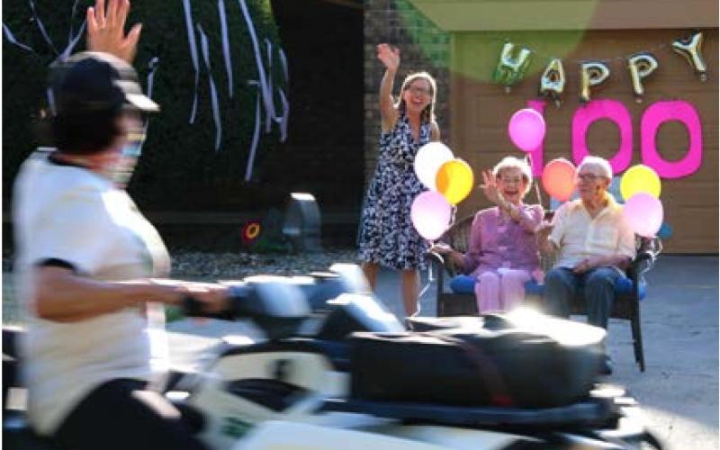 Cathy Reimeck, Hazel Cusac and Jake Amberg enjoy Hazel’s 100th Birthday parade.