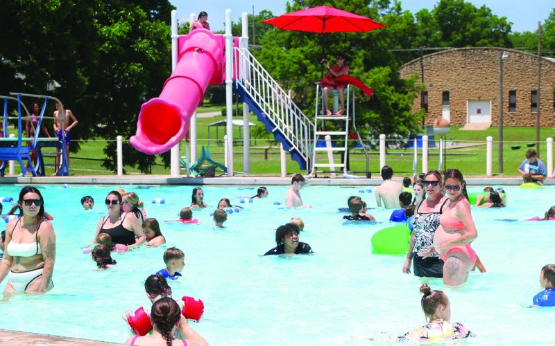 Dozens of swimmers enjoy the cool water of the Cushing Aquatic Center Monday, June 1. Air temperature was recorded at 97 degrees Monday, with flat top surfaces reaching up to 145 degrees according to AccuWeather. Photo by Allie Prater.