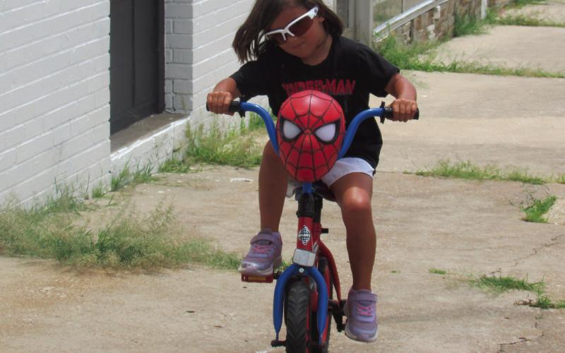 Ainsley flys down the sidewalk at the corner of Broadway and Cleveland — her family was following behind her as they enjoy a sunny day in the Downtown Cushing area. Photo by DeAnna Maddox