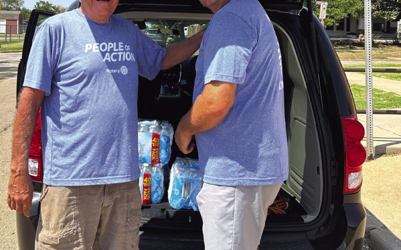 Rotarians Tyson Branyan and Mike Gaskins load cases of water into a van before they start making deliveries Tuesday, Aug. 6. Photo courtesy Nancy Dowell