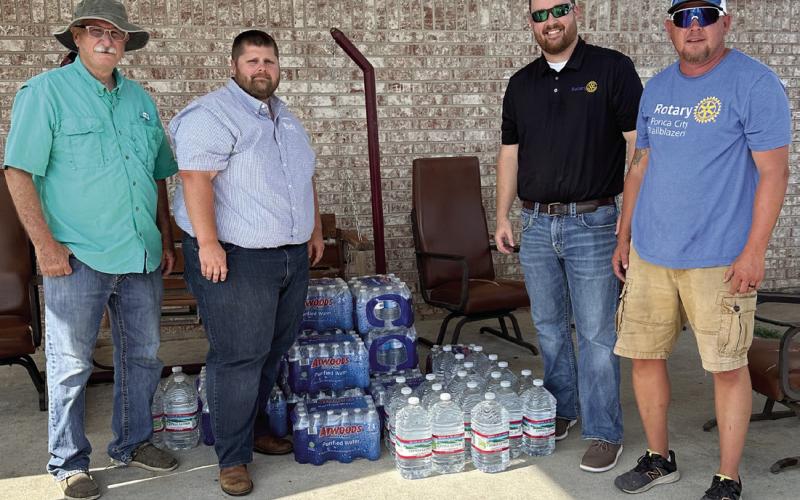 Rotarian Dale Dowell, volunteer Jacob Parker, Cushing Rotary President Tyler Stein, and Ponca City Trailblazers Rotarian George Davis stand on the back patio of Linwood Village assisted living in Cushing after unloading water donated by the Ponca City Trailblazers Rotary Club on Wednesday, Aug. 7. Photo courtesy Nancy Dowell