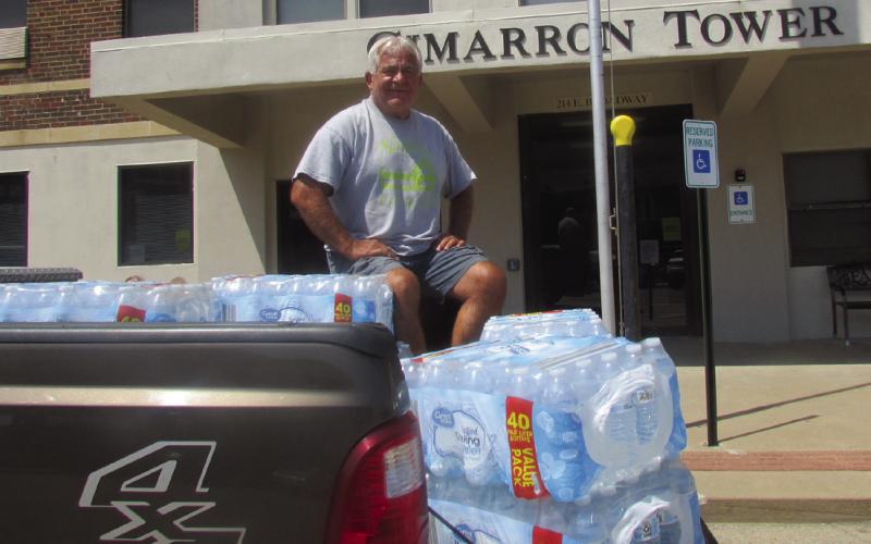 Cushing Rotarian John Rhoten used his personal vehicle to deliver packs of water to Cimarron Tower on Aug. 6, one day after the City of Cushing issued an emergency proclamation for immediate water rationing. This was part of a much larger effort from the Rotary Club and various other individuals, non-profits, and businesses to keep those in need supplied with water where necessary. Photo by DeAnna Maddox