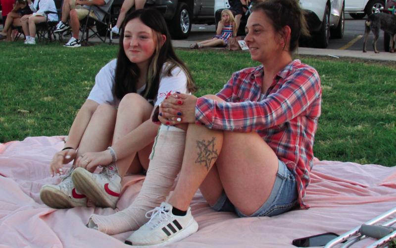 Reanna and Annie Lansford grabbed a blanket and took a spot in the grass to watch the firework display put on by Cushing Fire Department in Memorial Park on July 4.
